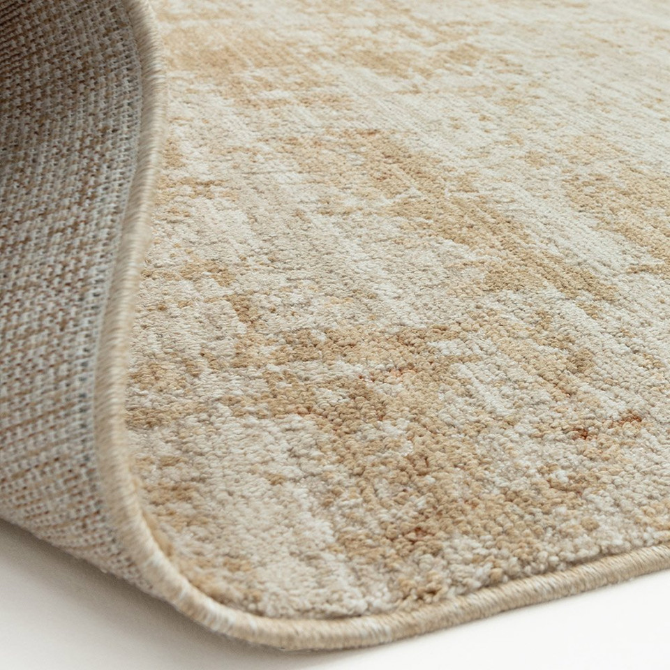 copper abstract rug partial fold on white floor