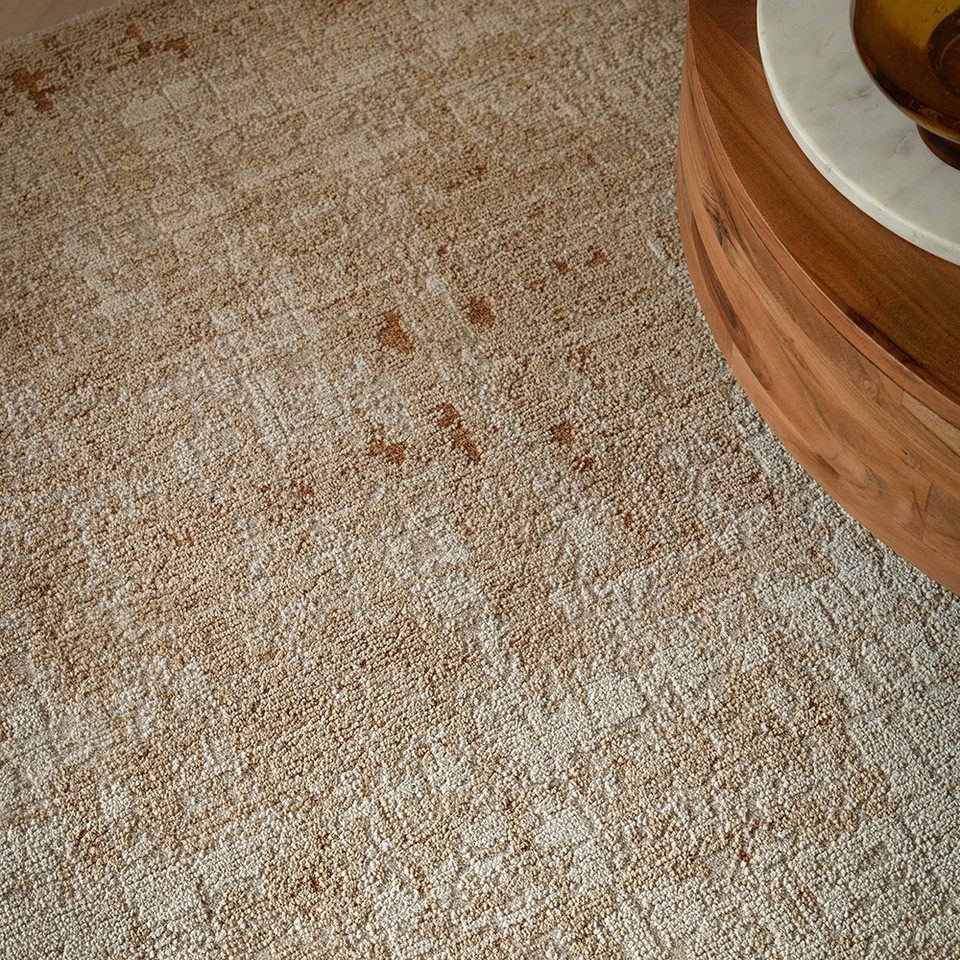 copper abstract rug in a living room with matching decor