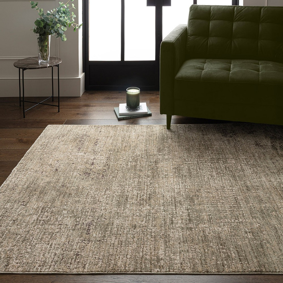 green abstract rug in a living room with matching decor