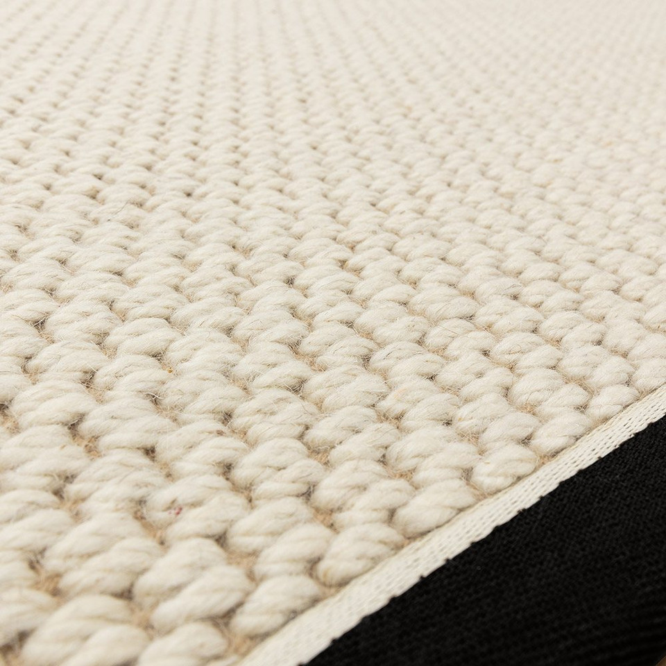 cream wool jute rug edge on wood floor