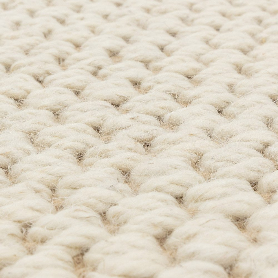 cream wool jute rug edge on wood floor