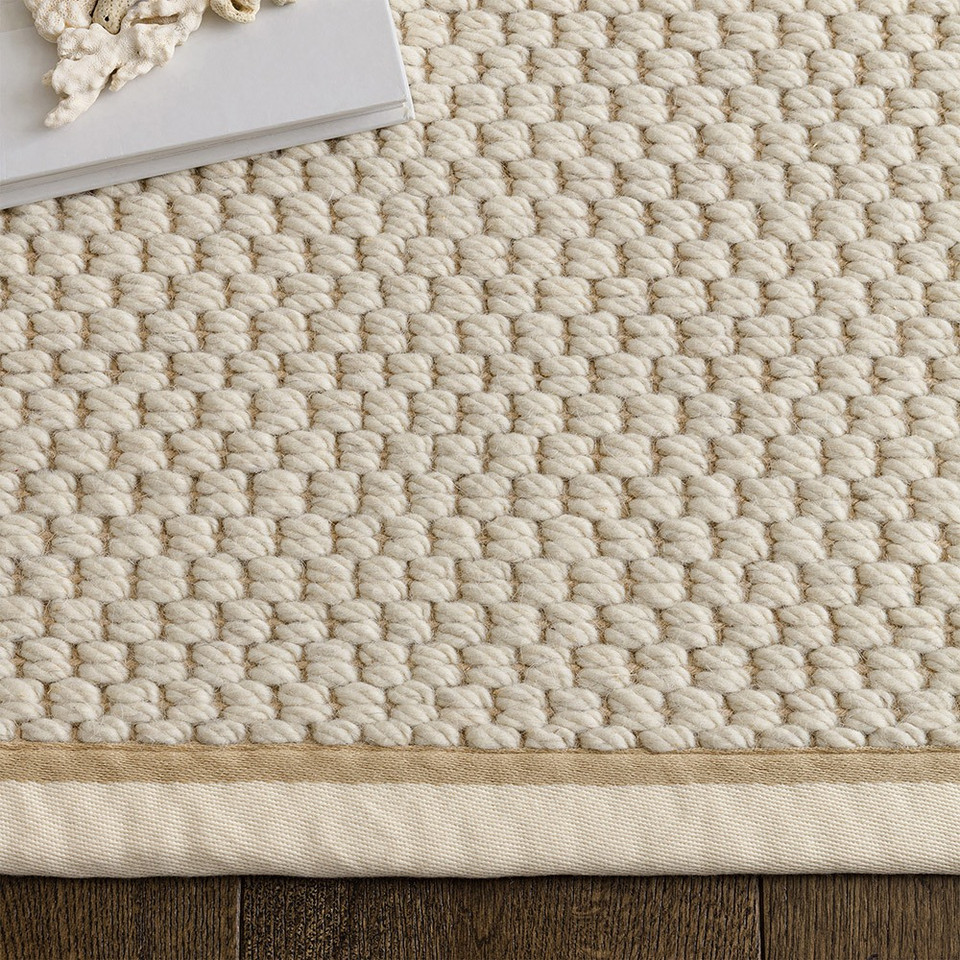 cream wool jute rug  edge on wood floor