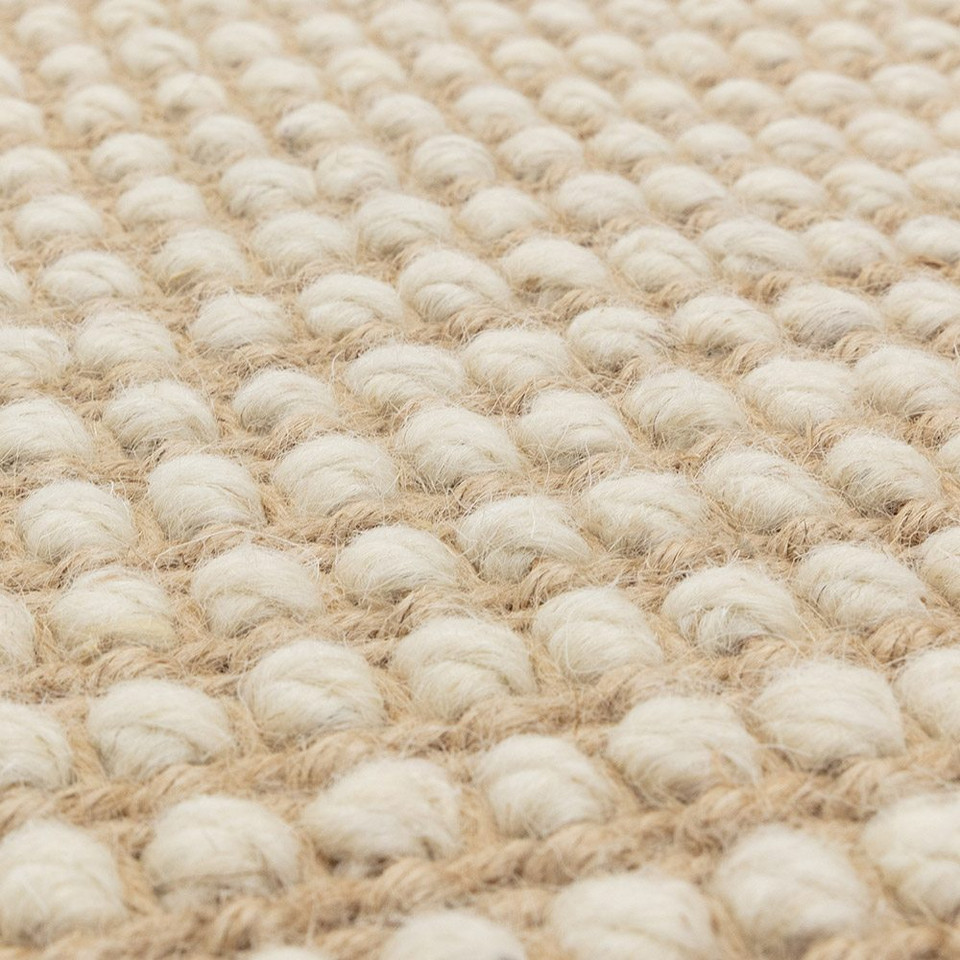 cream wool jute rug edge on wood floor
