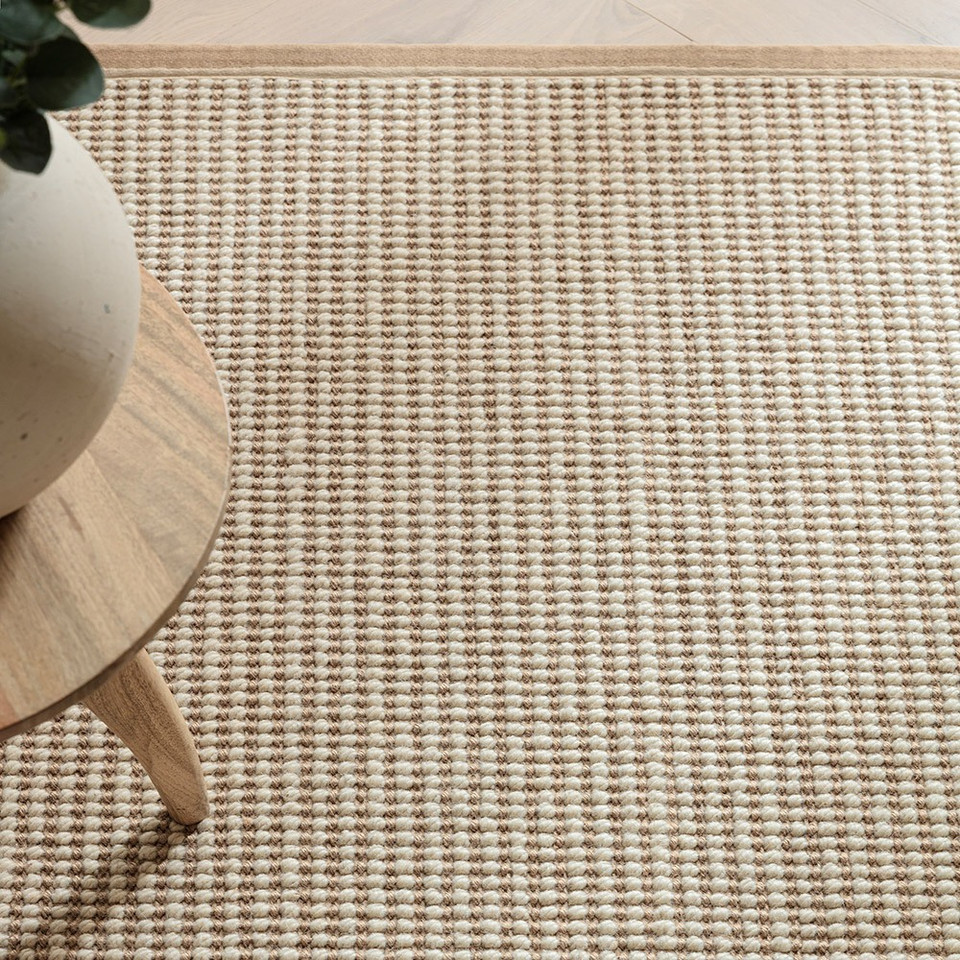 cream wool jute rug  edge on wood floor