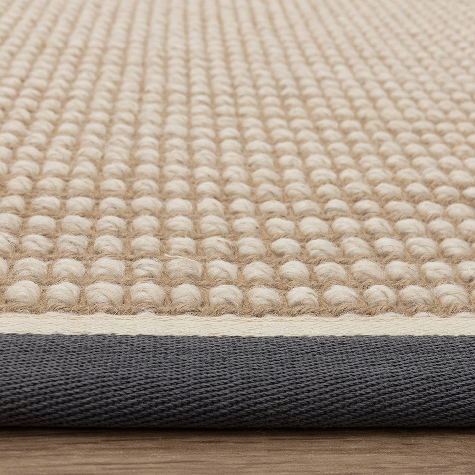 cream wool jute rug edge on wood floor