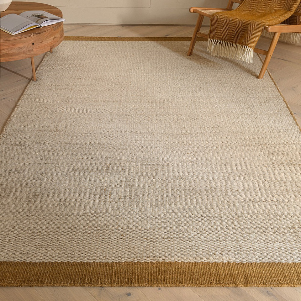 gold flatweave wool rug in a living room with matching decor