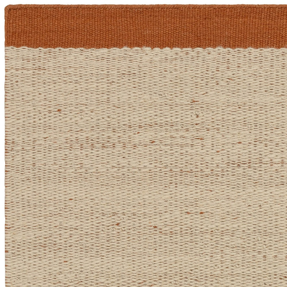 rust flatweave wool rug closeup corner
