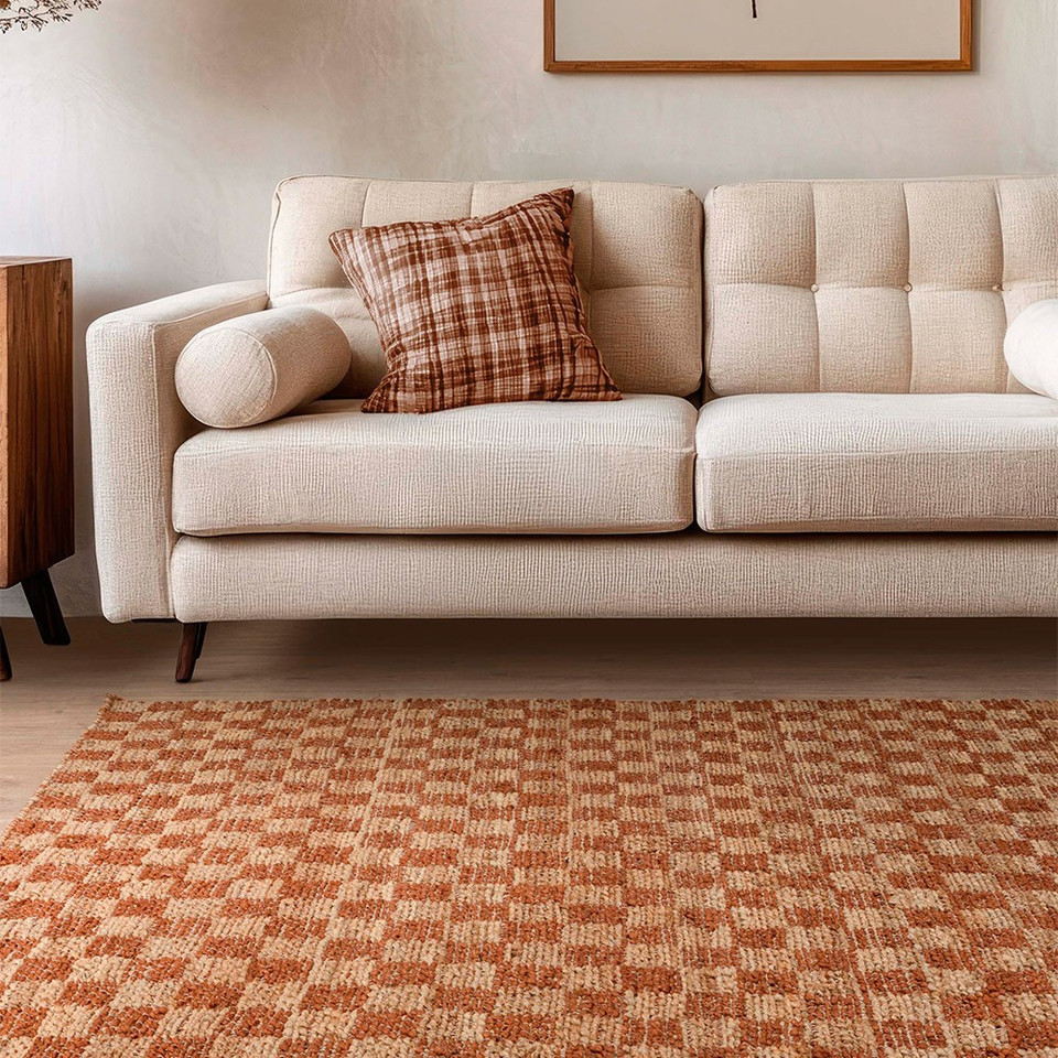 rust jute rug in a living room with matching decor