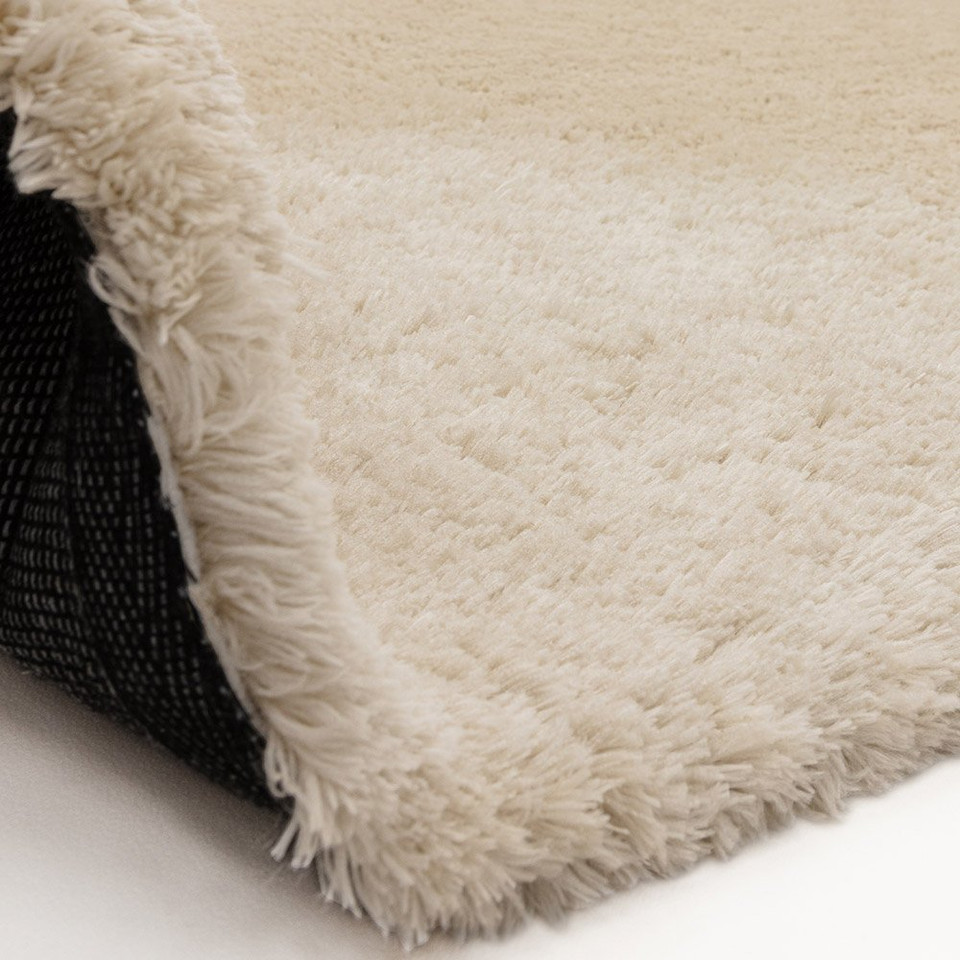 natural shaggy rug partial fold on white floor