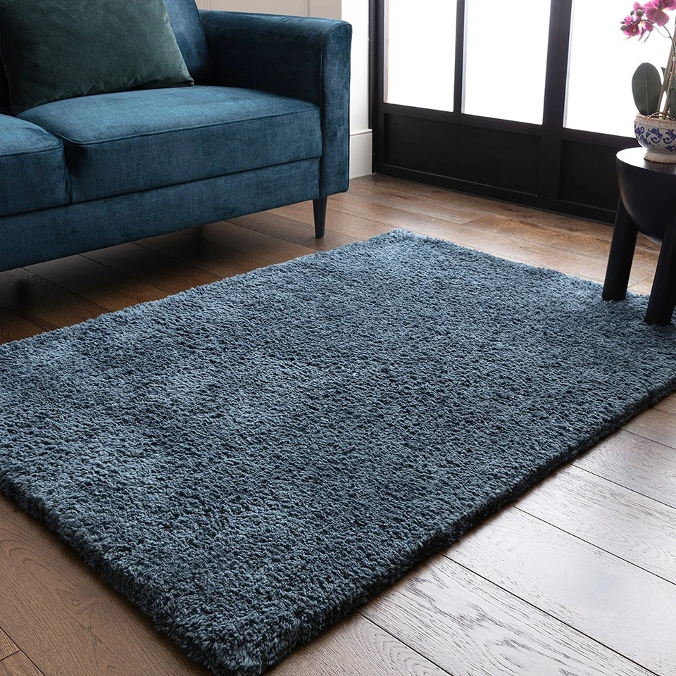 petrol shaggy rug in a living room with matching decor