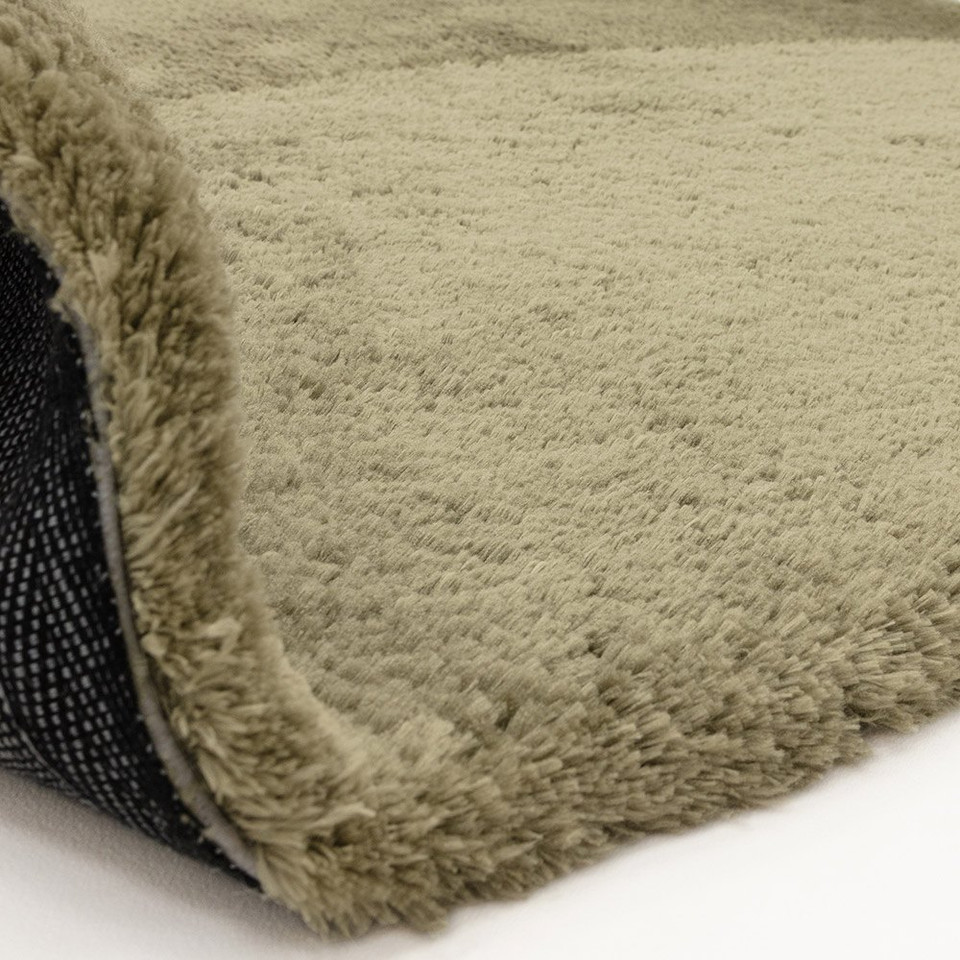 sage shaggy rug partial fold on white floor