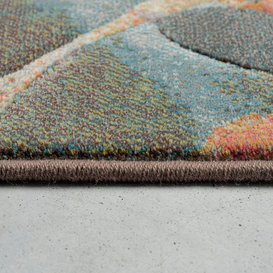 multicolour abstract rug closeup border on white floor
