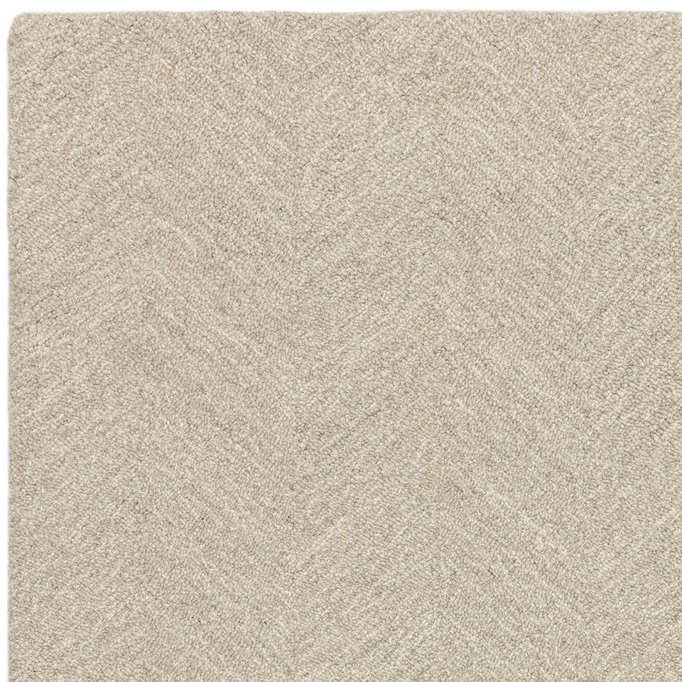 Overhead studio crop focusing on the geometric corner design and subtle cream linear accents of a sand chevron wool rug.