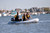 Achilles SPD-310E inflatable dinghy with outboard on the water.
