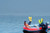 Achilles SGX-132 sport utility inflatable boat with outboard and divers.