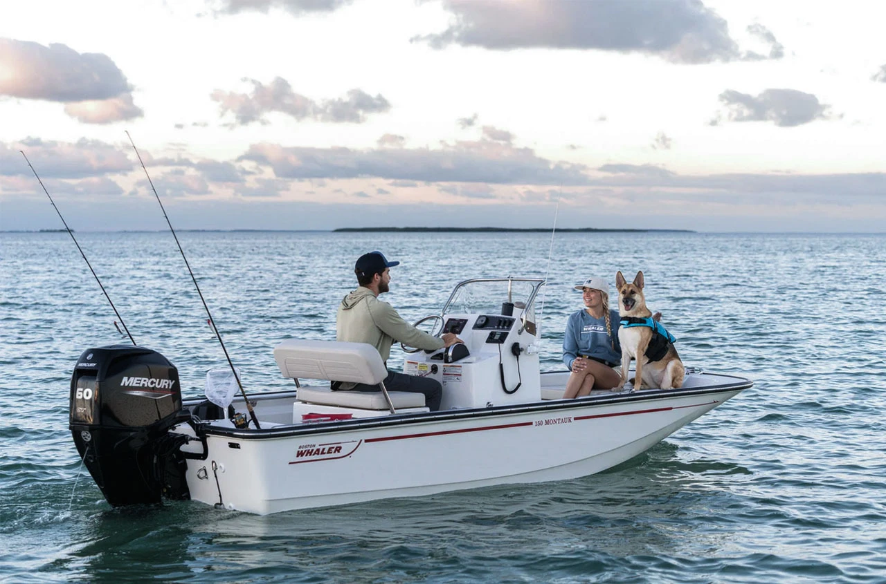 Happy couple with a dog on a Boston Whaler