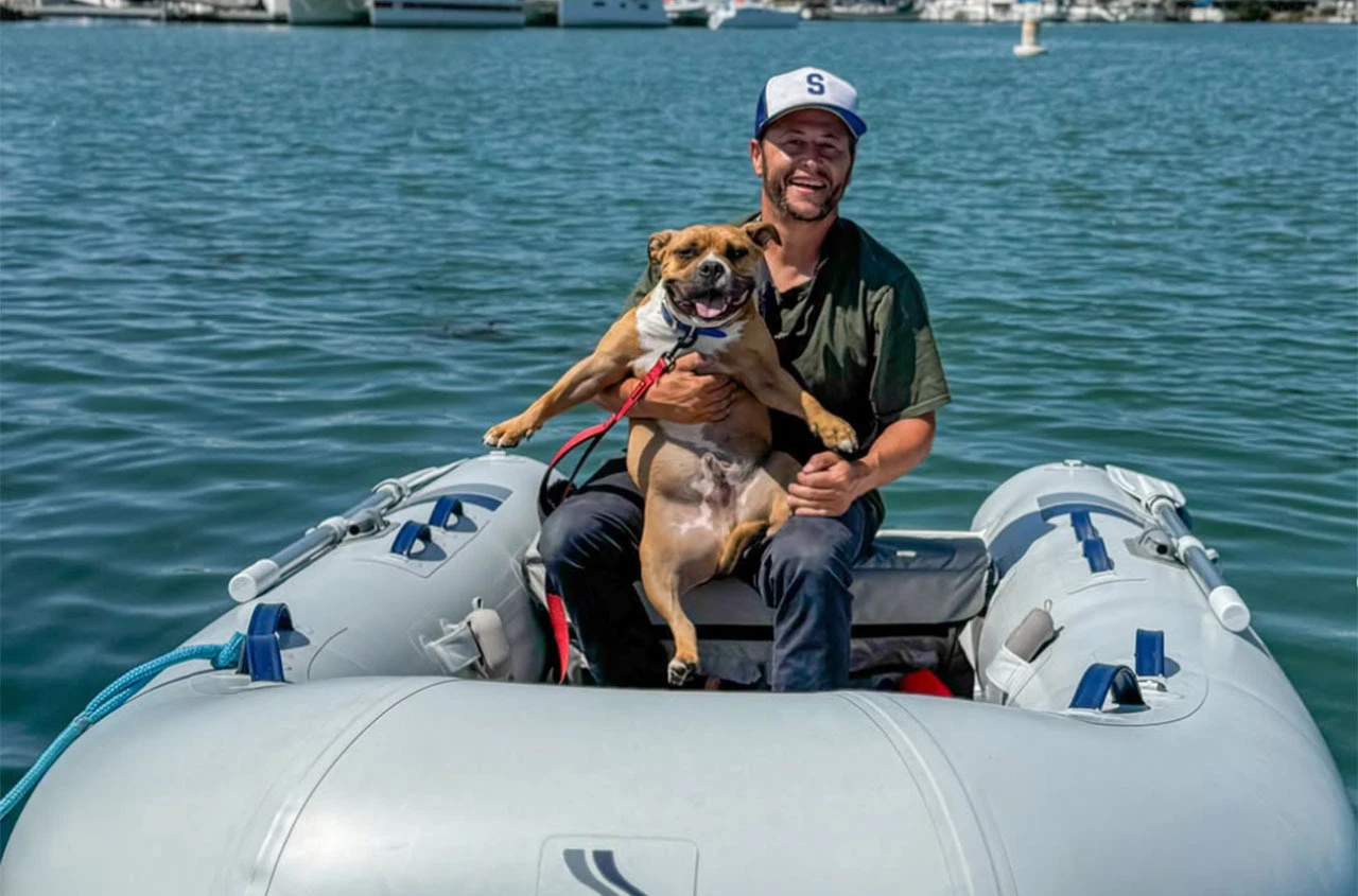 Man with dog on a Highfield Dinghy