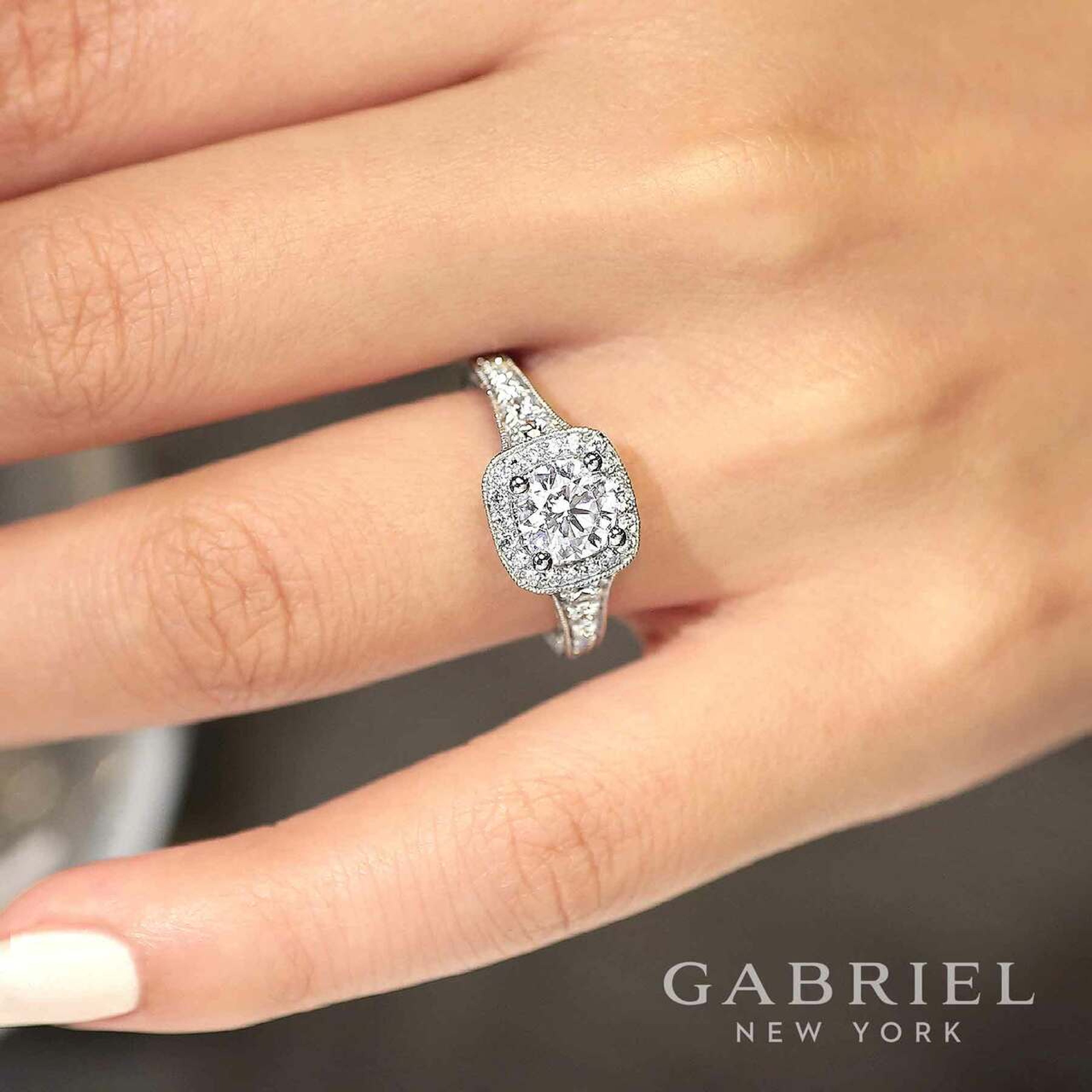 14K gold cushion halo engagement ring with diamond encrusted band and scrollwork detailing