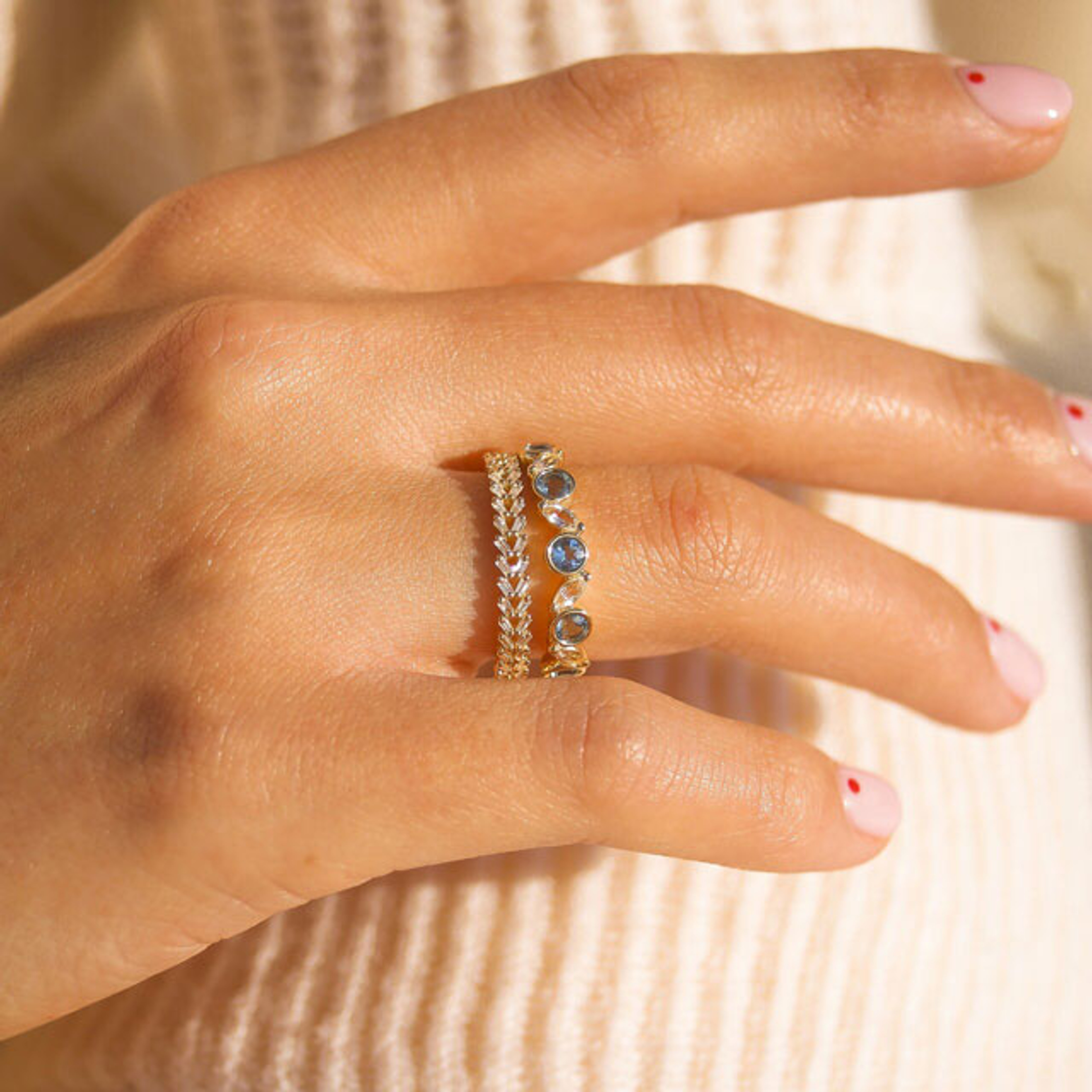 10K yellow gold stacking ring with alternating bezel set round blue topaz and marquise shaped white topaz