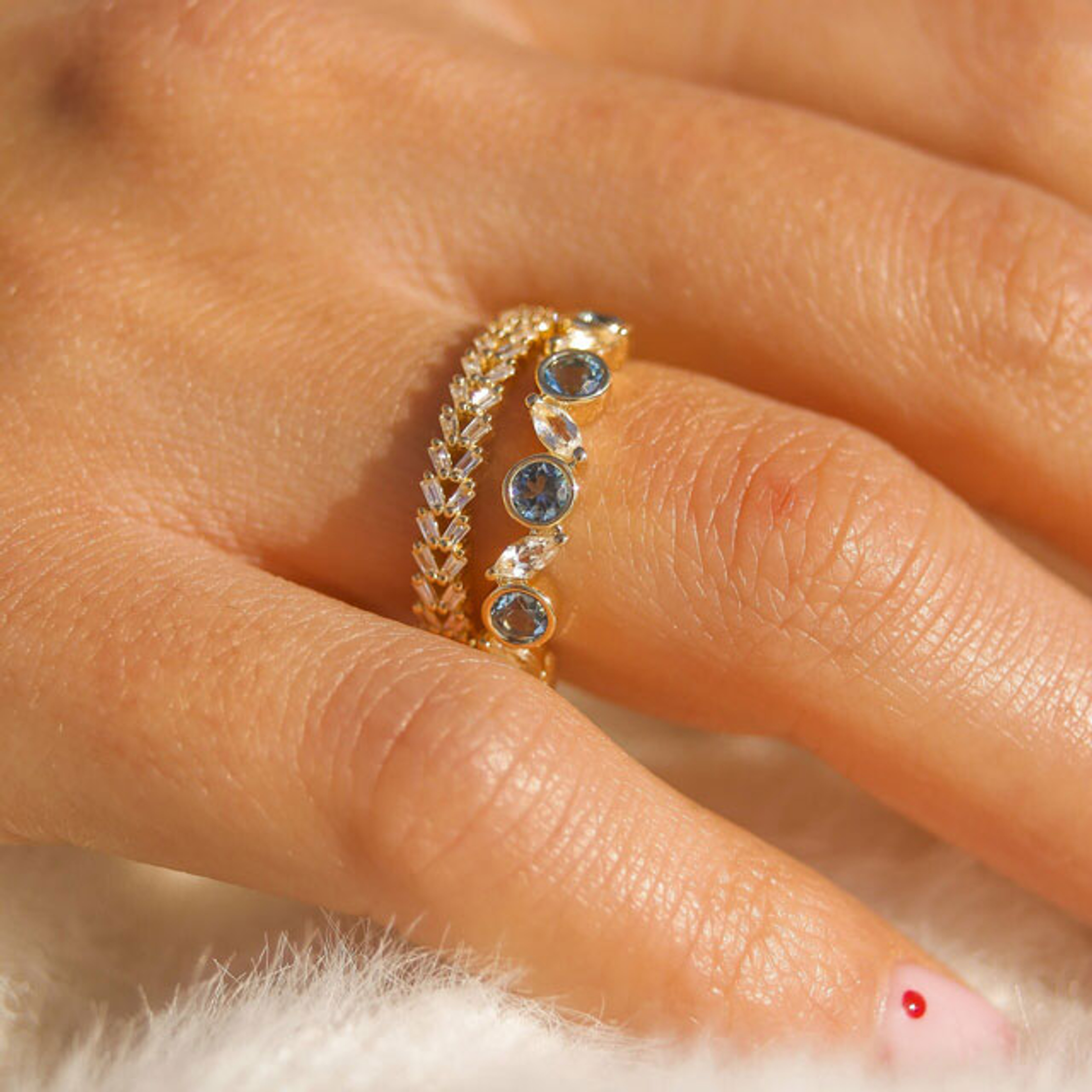 10K yellow gold stacking ring with alternating bezel set round blue topaz and marquise shaped white topaz