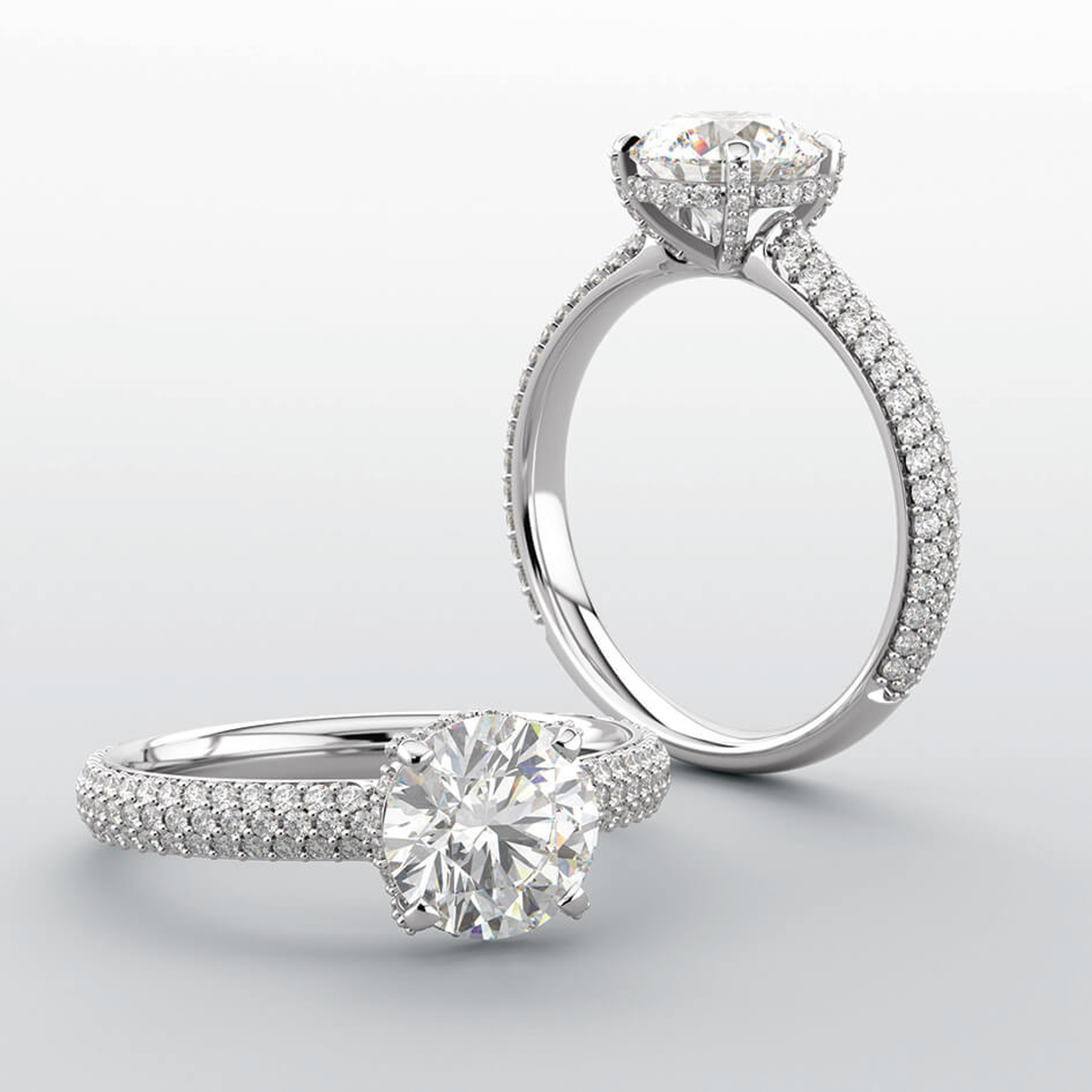 straight engagement ring with 3 rows of micropave diamonds and a hidden halo of diamonds on a diamond accented band