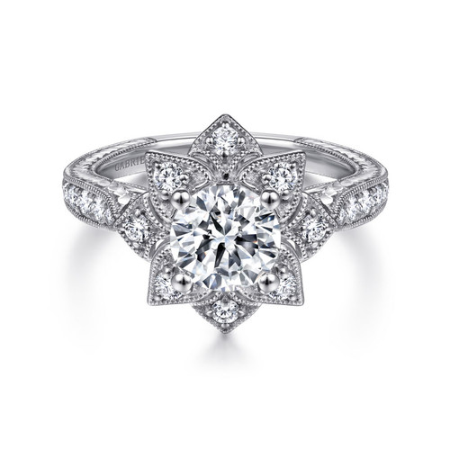 vintag-insired engagement ring with floral halo around a round moissanite center stone with channel set natural diamonds in the setting and milgrain detailing