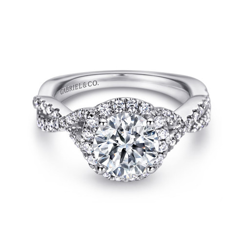 halo engagement ring with round moissanite center stone and criss-cross band with pave diamonds