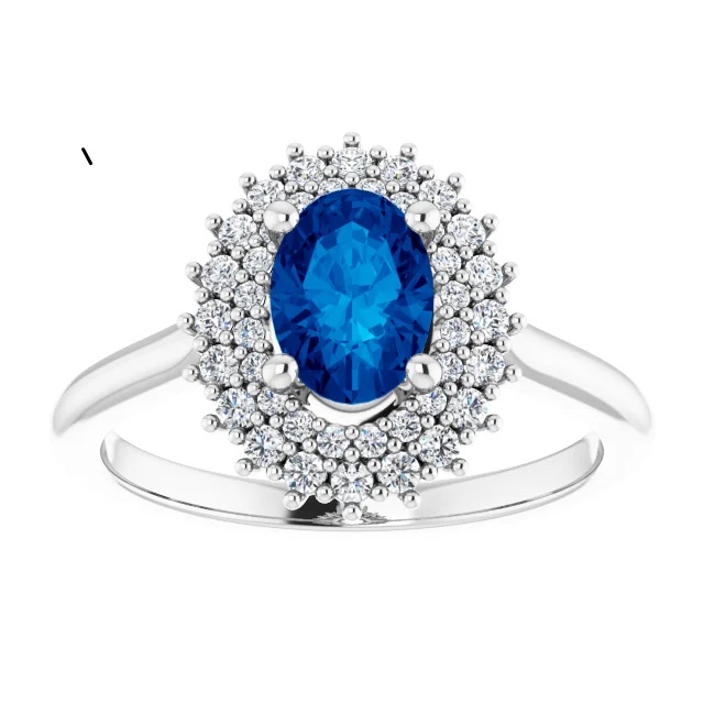 14K gold double halo engagement ring with an oval lab grown blue sapphire center stone and lab grown diamond accents in the halo with a polished band