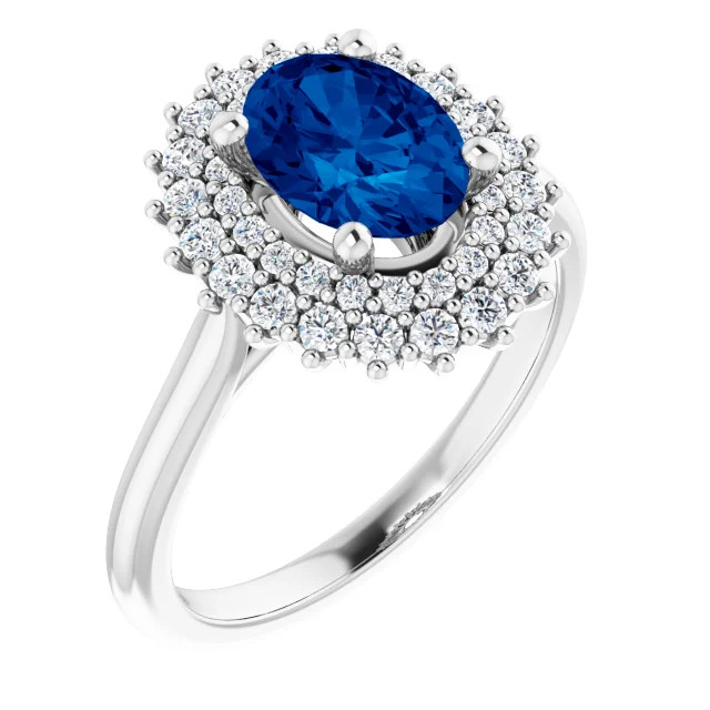 14K gold double halo engagement ring with an oval lab grown blue sapphire center stone and lab grown diamond accents in the halo with a polished band