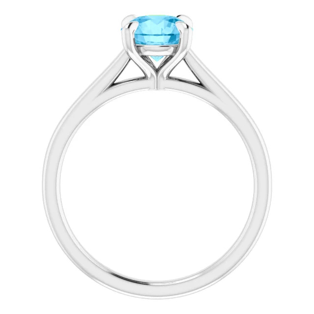 14K gold solitaire engagement ring with round blue topaz center stone and polished band