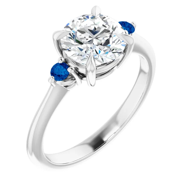 three stone engagement ring with round moissanite center stone and lab grown sapphire accent stones on each side with a polished band