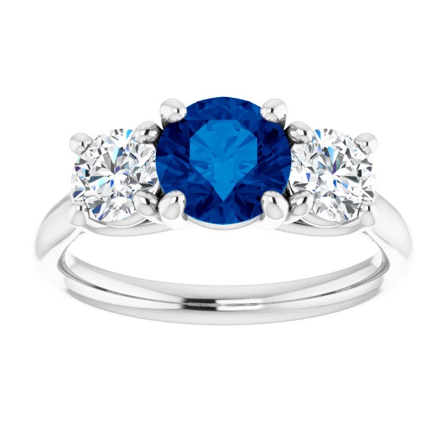 14K gold three stone engagement ring with round blue sapphire center stone and diamond side stones with a polished band