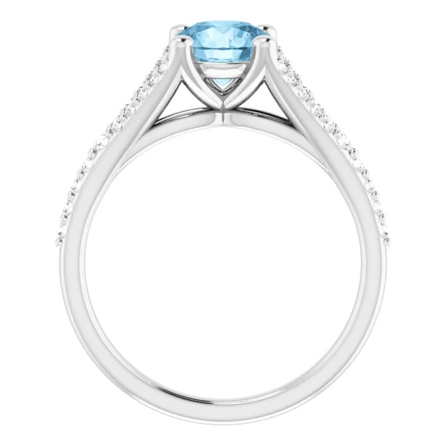 14K gold spit shank engagement ring with round blue topaz center stone and lab grown diamond accented band