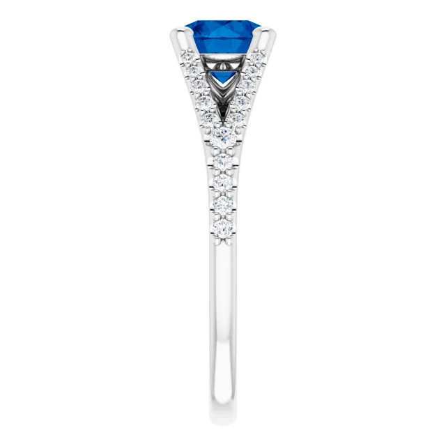 14K gold spit shank engagement ring with round blue sapphire center stone and lab grown diamond accented band