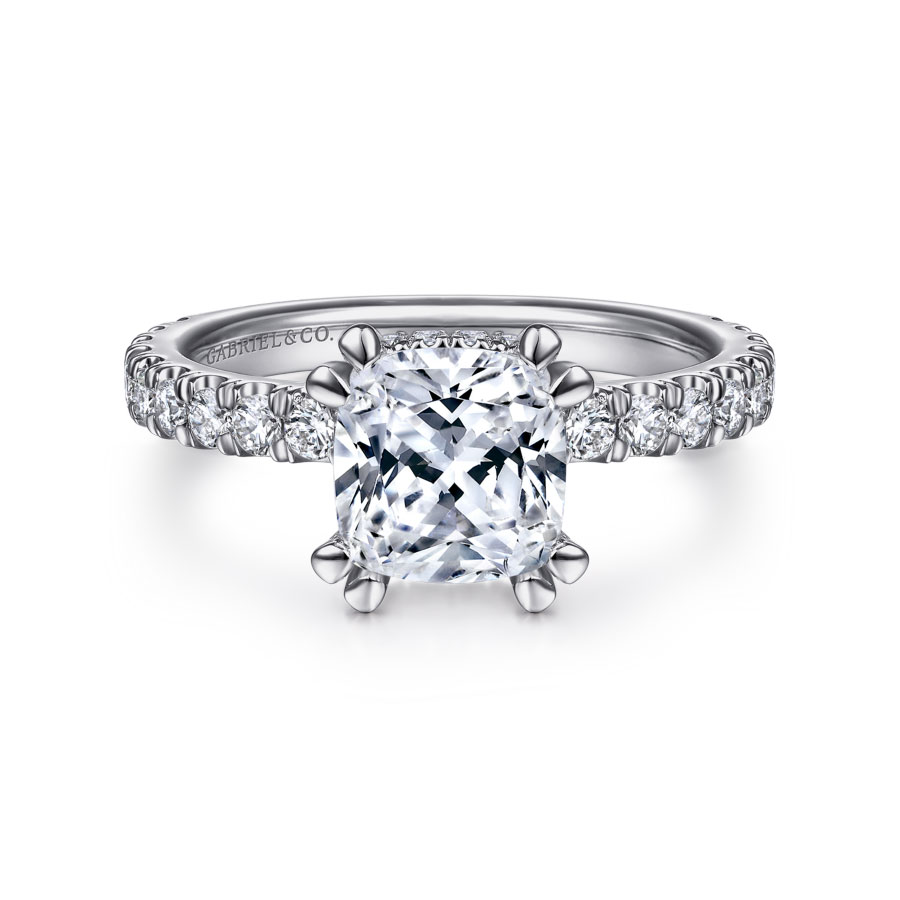 straight engagement ring with cushion cut moissanite center stone and hidden halo of natural diamond accents with diamond accented band