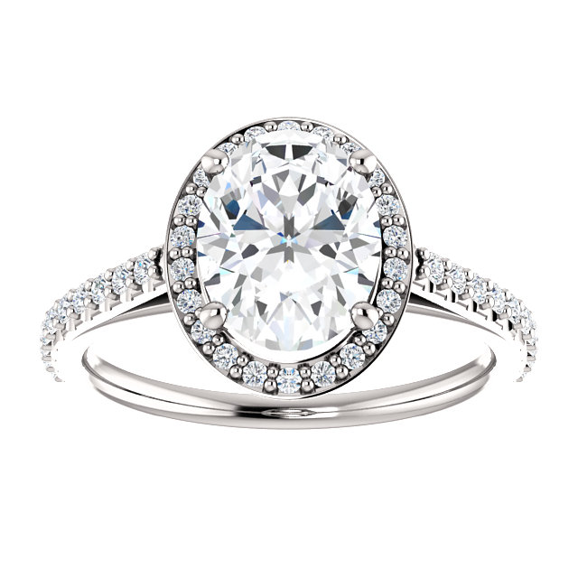 halo engagement ring with oval shaped moissanite center stone and diamond accented halo and band