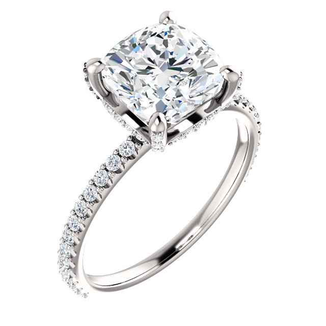 straight engagement ring with cushion cut moissanite center stone and hidden halo of diamonds with diamond accented band and prongs