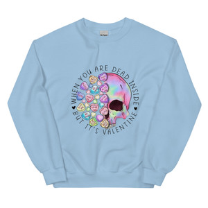 Crew neck sweatshirt shown flat featuring a skull surrounded by pastel Valentine heart candies. Text reads “When You’re Dead Inside” in bold lettering above the skull. Design combines dark humor with playful Valentine colors.