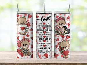 20oz skinny stainless steel tumbler shown upright with vertical hydration reminder prompts down the center. Cute Valentine teddy bears and heart accents surround the reminders in soft pastel colors. Glossy finish with clear sliding lid attached.