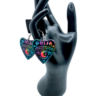 The bright tye dye colors on the black contrast of these mystical ouija board earrings are a new necessety. Do not pass by the tye dye trend of these Beautiful earrings. Made of durable qualtiy acrylic and stainless steel hooks. These earrings are the most fun way to express yourself. These earrings are so charming. The perfect addition to any jewelry box. Perfect gift for a loved one or buy for yourself. These earrings scream a genuine sense of style!