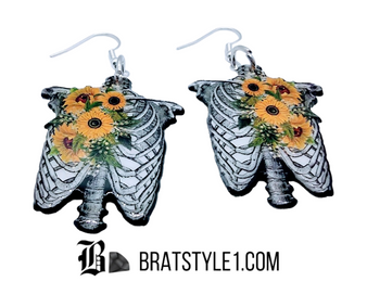These half torso skeleton earrings are delightfully elegant with the added bouquet of sunflowers. This jewelry adds a flash of grunge with a sweet side.