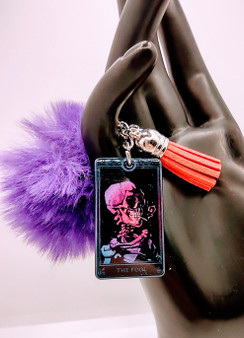 The fool Tarot Card Style Acrylic Keychain is made to celebrate the natural magic of Tarot. The delicate keychain features the fool card. The fur and tassel add an extra bit of detail. This unique keychain makes the perfect gift for anyone! Acrylic Keychain is made with 100% premium acrylic. This keychain makes the perfect gift for all. Our designers carefully choose every material to bring you the best quality and craftsmanship possible. Though the color of the fur may vary upon delivery due to availability, each keychain features an original unique design.