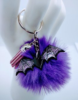 This acrylic keychain is adorned with a furry ball and tassel to give you that extra edge when you need it most. If you're looking for something special to show your personality, the Bat is perfect for any occasion. So don't wait any longer - get yourself a Bat today! Though the color of the fur may vary upon delivery due to availability, each keychain features an original unique design.