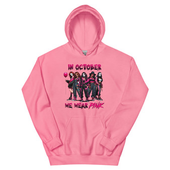 Hoodie featuring full-body illustrations of girls dressed as classic horror movie characters in pink outfits, with the phrase “In October We Wear Pink.” Soft, cozy, and Halloween-ready.