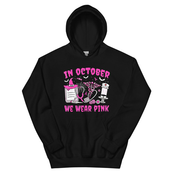 Hoodie featuring pink nurse-themed graphics with a nurse hat and the phrase “In October We Wear Pink.” Cozy, unisex, and Halloween-ready.