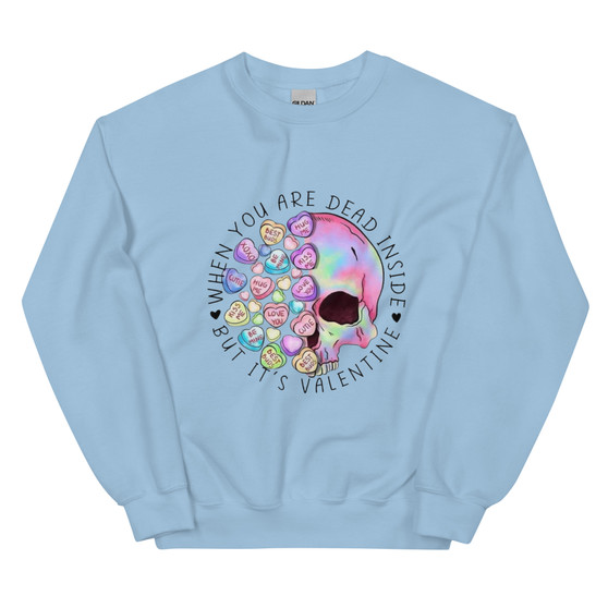 Crew neck sweatshirt shown flat featuring a skull surrounded by pastel Valentine heart candies. Text reads “When You’re Dead Inside” in bold lettering above the skull. Design combines dark humor with playful Valentine colors.