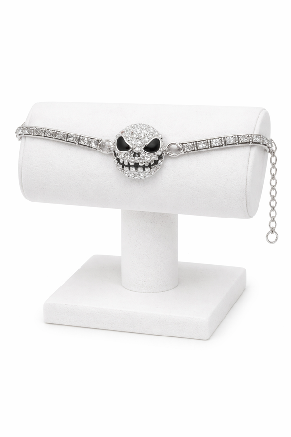 Features a rhinestone skull bracelet showcased across multiple views, including a crisp white background product shot, a clean display stand image for structure and shape, a close-up worn-on-wrist lifestyle photo for scale, and a styled flat lay with dark, gothic-inspired elements to highlight its edgy aesthetic and sparkle.