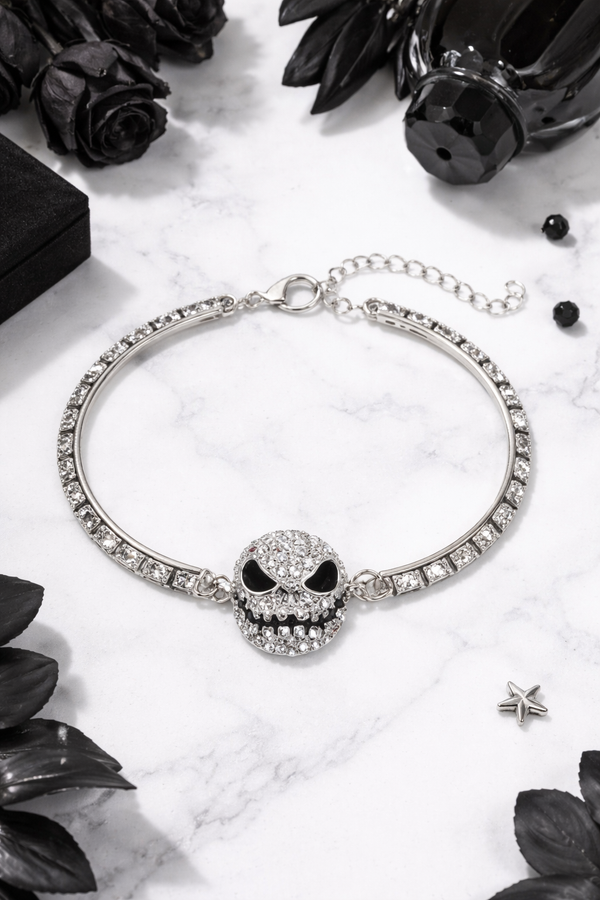 Features a rhinestone skull bracelet showcased across multiple views, including a crisp white background product shot, a clean display stand image for structure and shape, a close-up worn-on-wrist lifestyle photo for scale, and a styled flat lay with dark, gothic-inspired elements to highlight its edgy aesthetic and sparkle.
