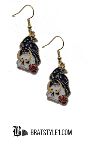 A curated set of Mystic Charm earrings featuring intricate, gothic-inspired designs with enamel detailing and gold-tone hooks. Styled across a mix of clean product shots and moody, aesthetic backgrounds, this collection blends dark elegance with a mystical edge. Each piece showcases unique character and craftsmanship, perfect for adding a bold, alternative statement to any look.