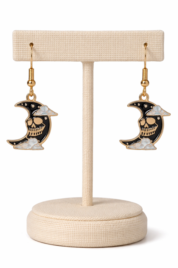 A curated set of Mystic Charm earrings featuring intricate, gothic-inspired designs with enamel detailing and gold-tone hooks. Styled across a mix of clean product shots and moody, aesthetic backgrounds, this collection blends dark elegance with a mystical edge. Each piece showcases unique character and craftsmanship, perfect for adding a bold, alternative statement to any look.